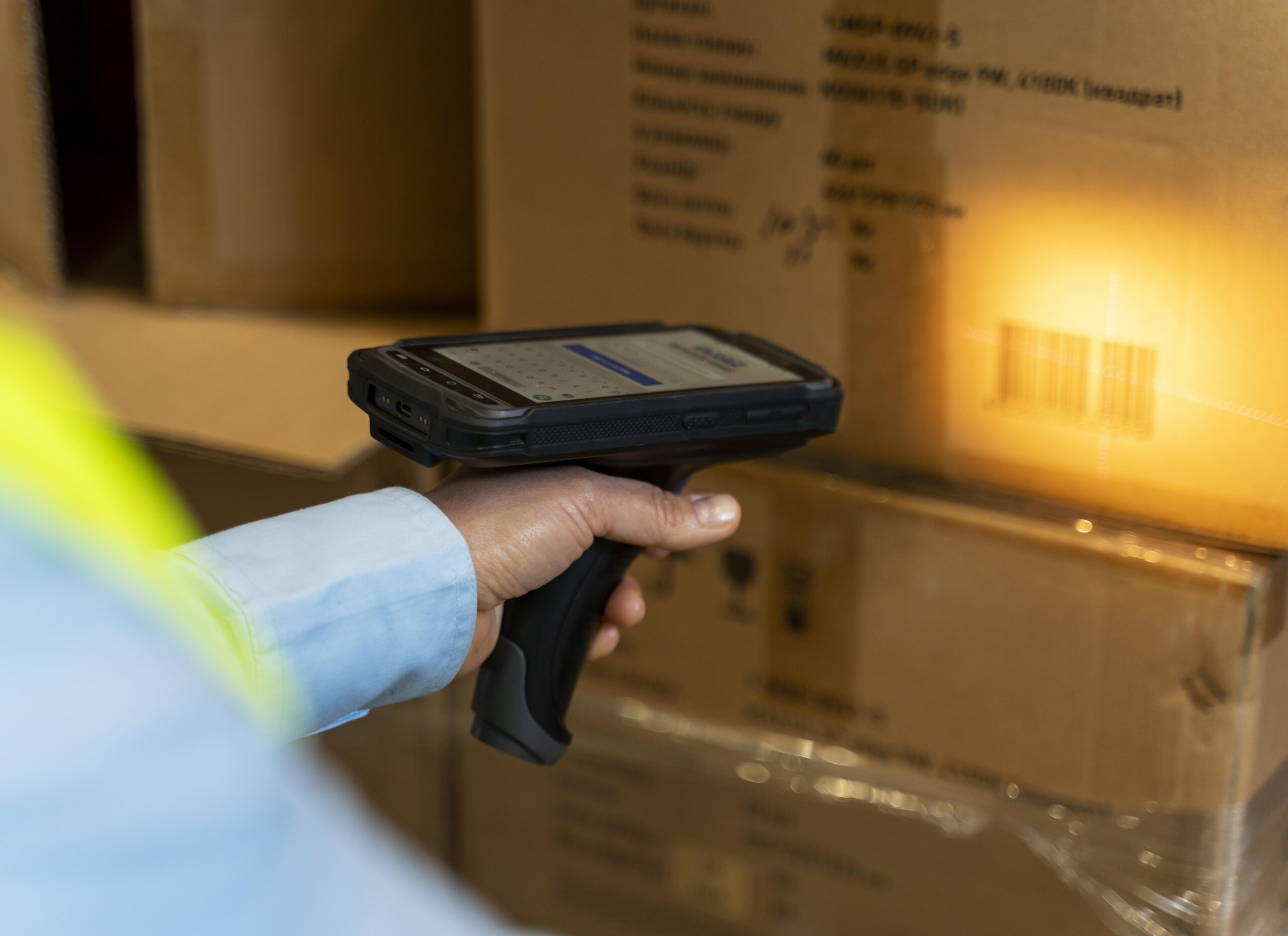 Warehouse worker scanning freight barcode label for NMFC classification and shipment documentation