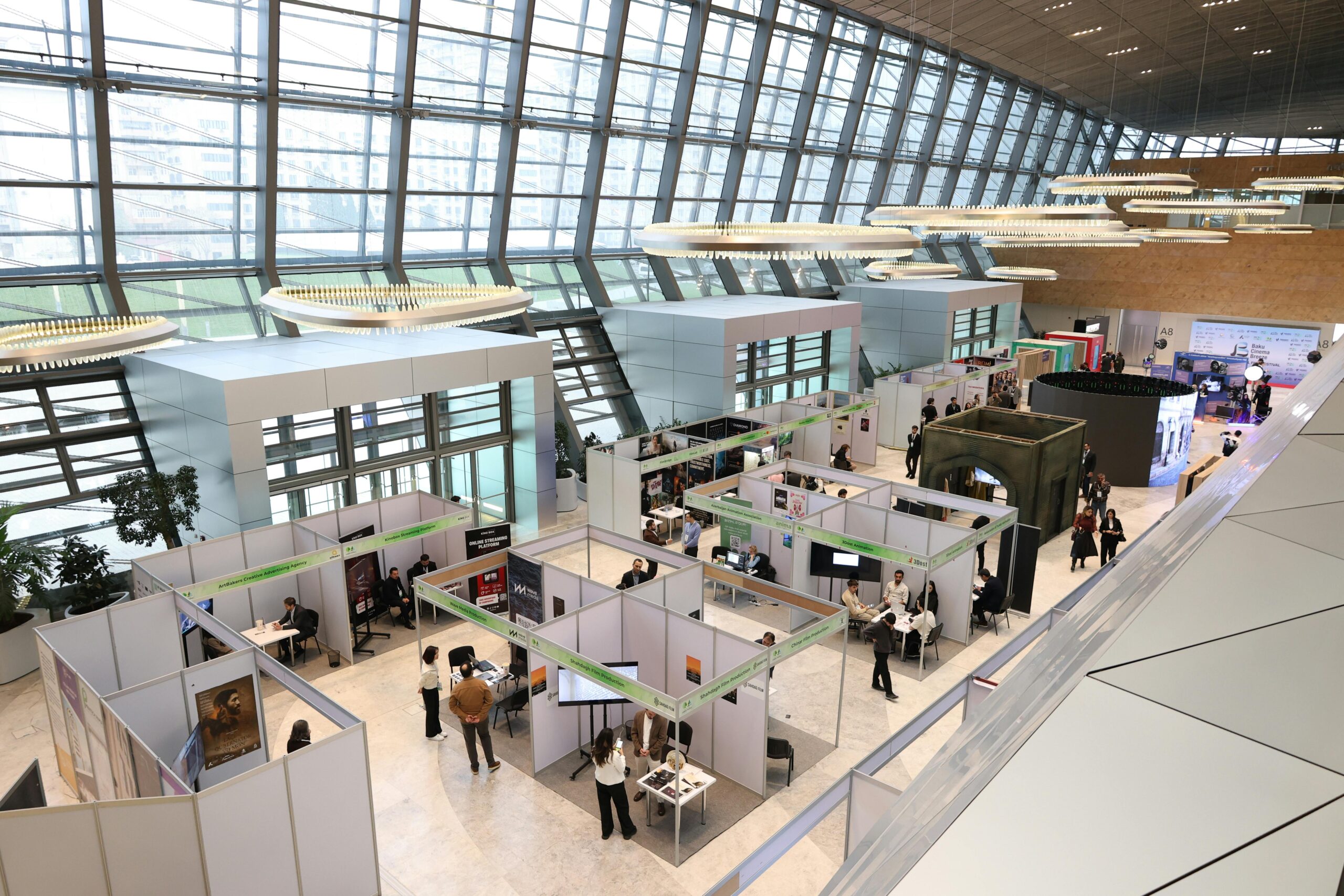 aerial view of trade show exhibit floor with booths and attendees